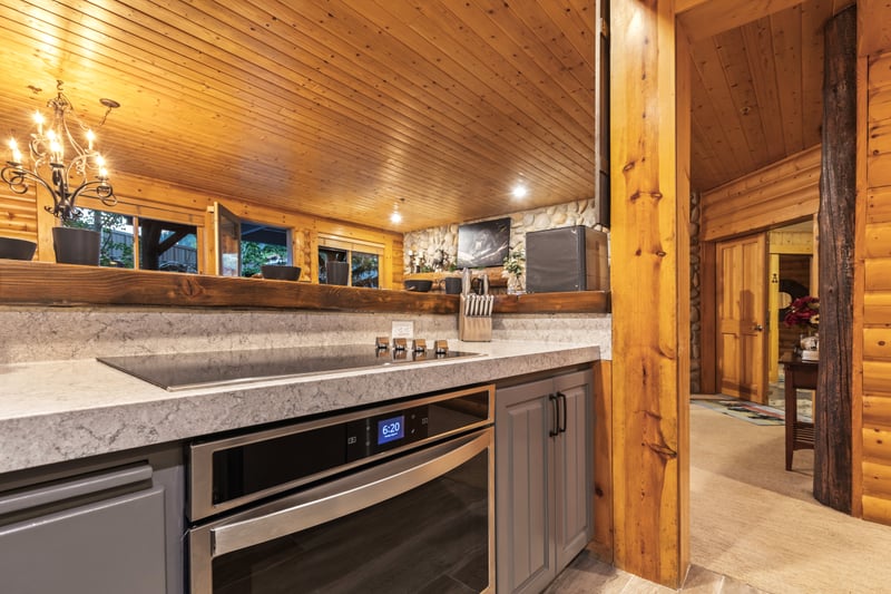 Granite counters, full-size appliances, and sleek cabinetry make cooking and entertaining easy.