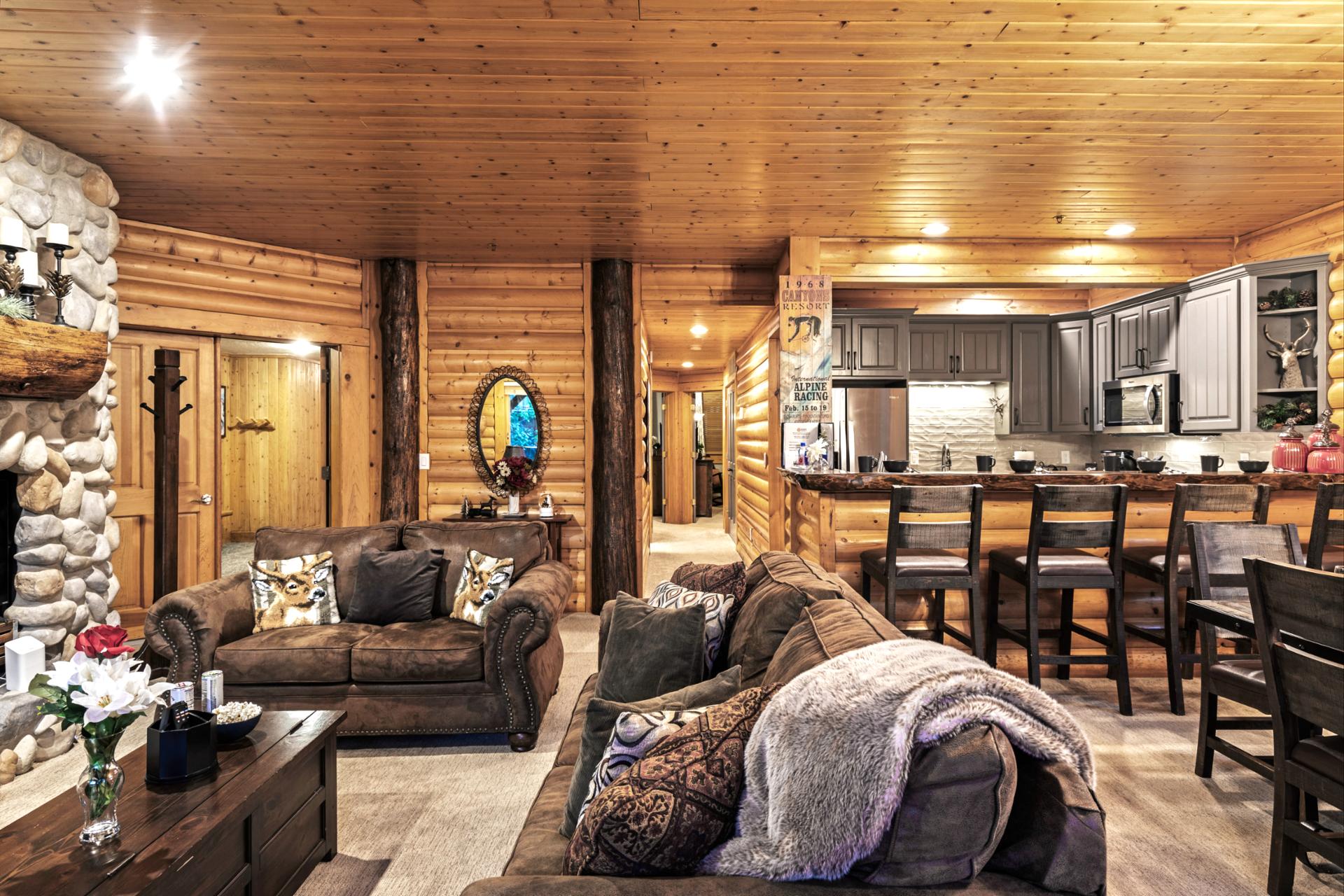 Cabin-inspired comfort meets convenience in this open-plan great room with a fireplace and Smart TV.