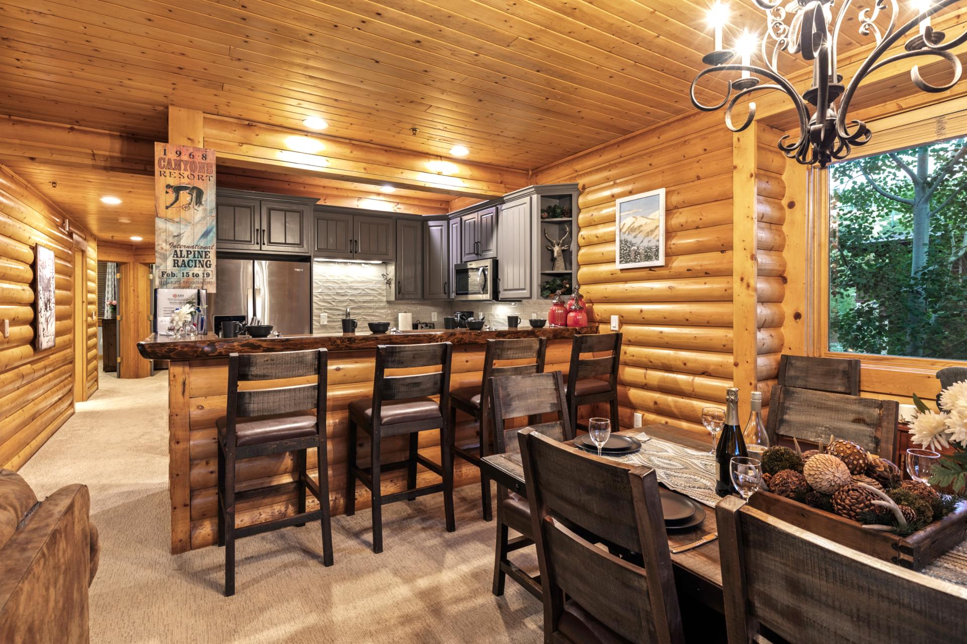 Dine together beneath the lodge-style chandelier in this open dining area with seating for six.