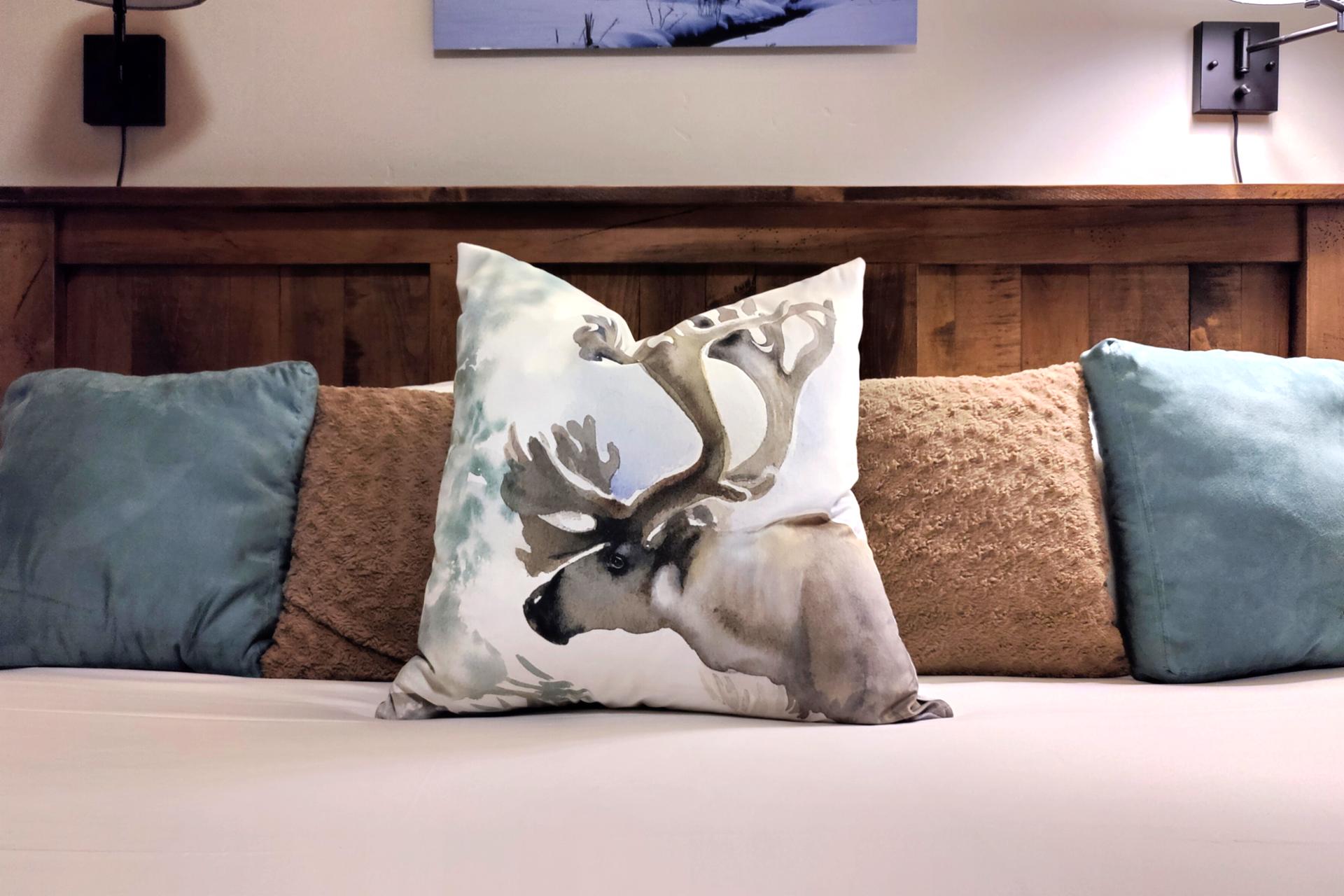 Plush bedding and mountain textures invite restful nights in the primary bedroom.