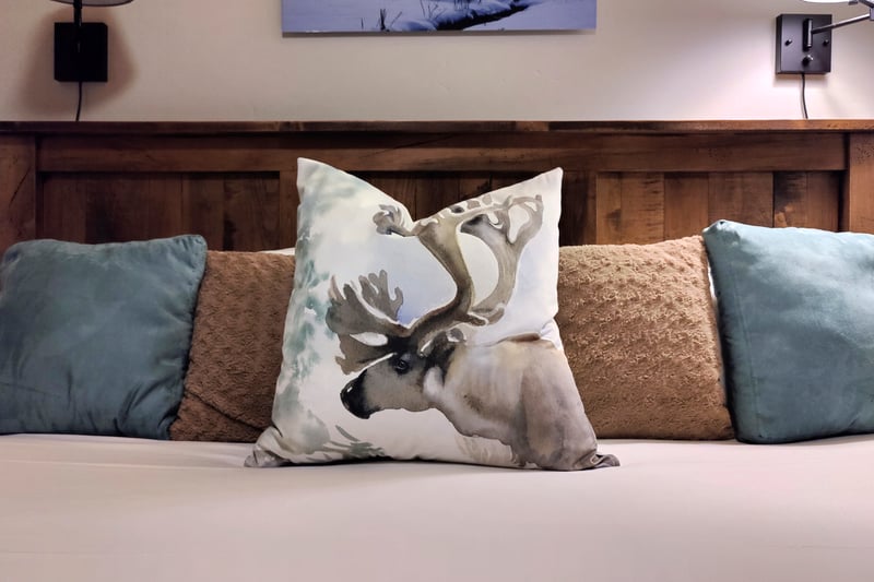 Plush bedding and mountain textures invite restful nights in the primary bedroom.