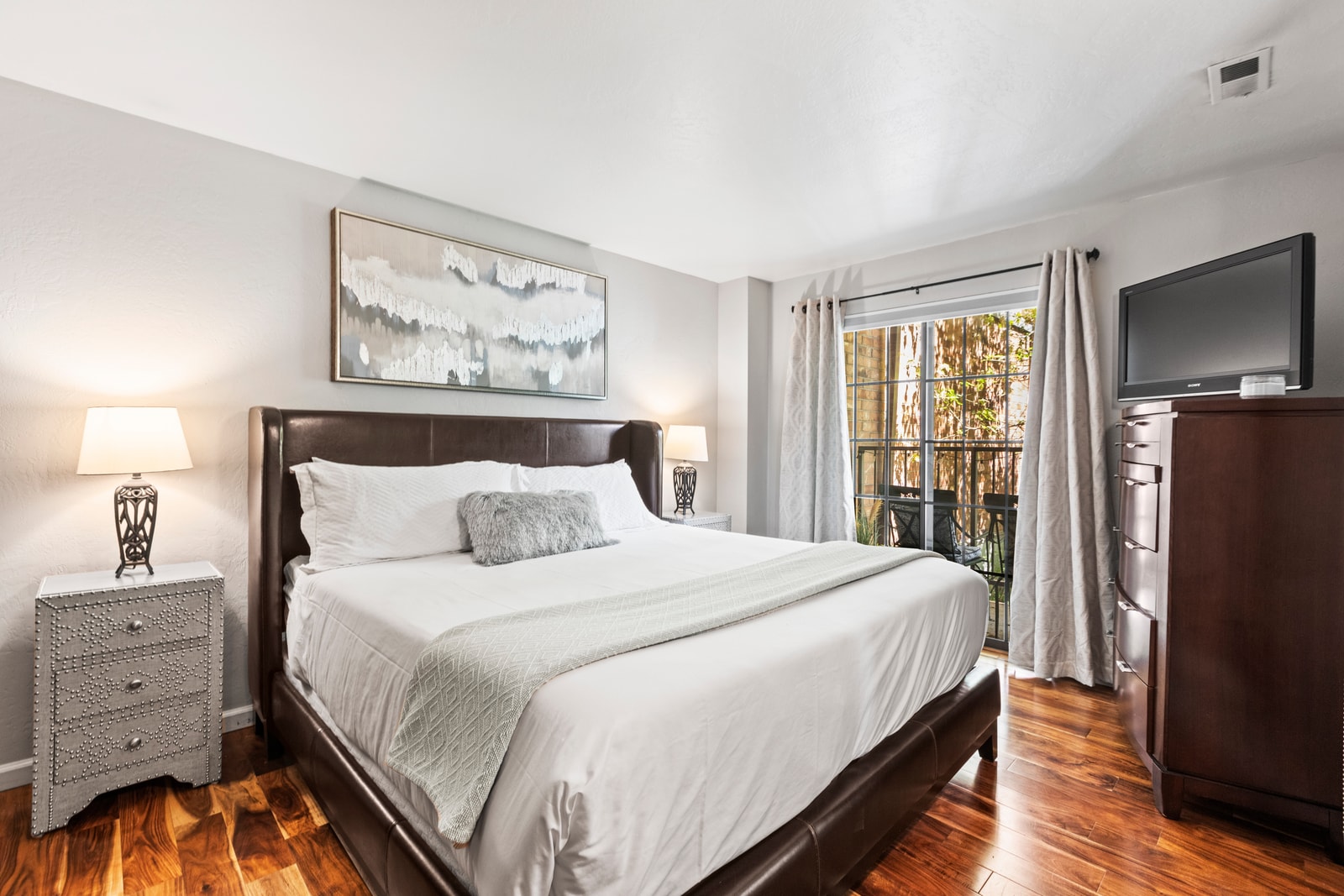 Rest easy in the King bed with plush linens and enjoy morning light from the private deck.