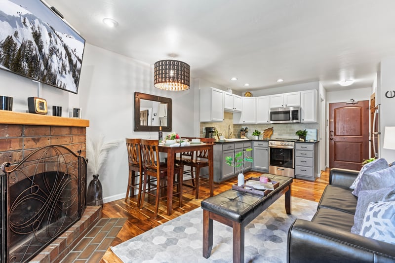 Warm wood tones and an electric fireplace create a welcoming setting for shared meals or game nights.
