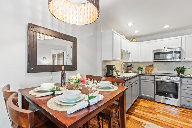 Share meals or a bottle of wine at the four-seat dining table beneath a stylish pendant light.