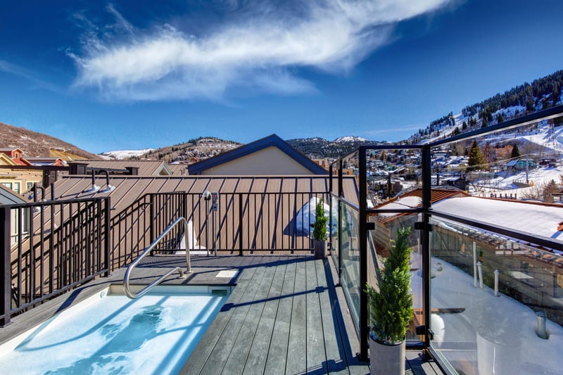 View from Common Rooftop: Another rooftop hot tub view with bright blue skies.