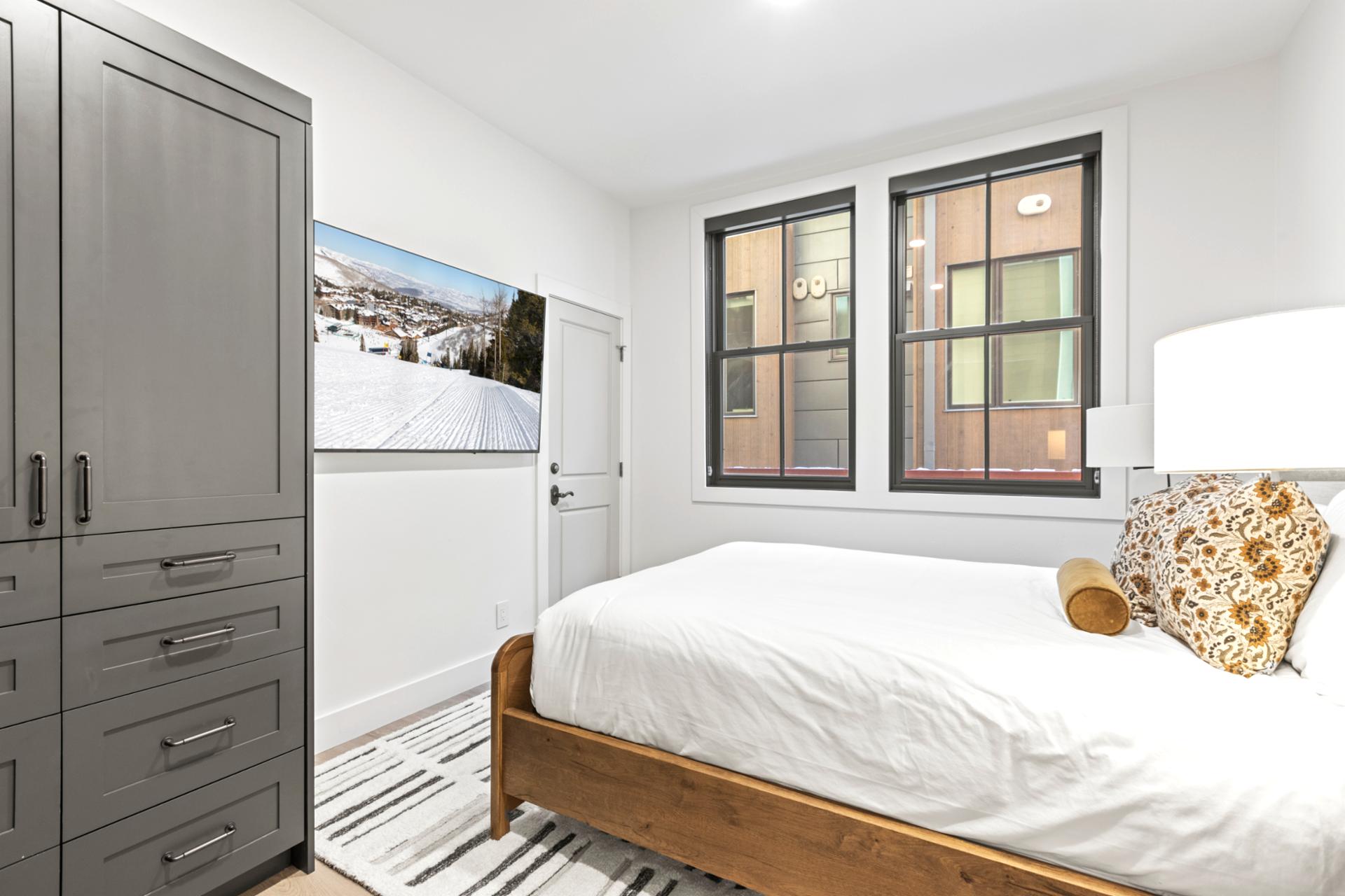 Full view of the bedroom layout, including nightstands, dresser, and closet.