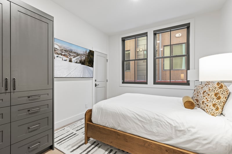 Full view of the bedroom layout, including nightstands, dresser, and closet.