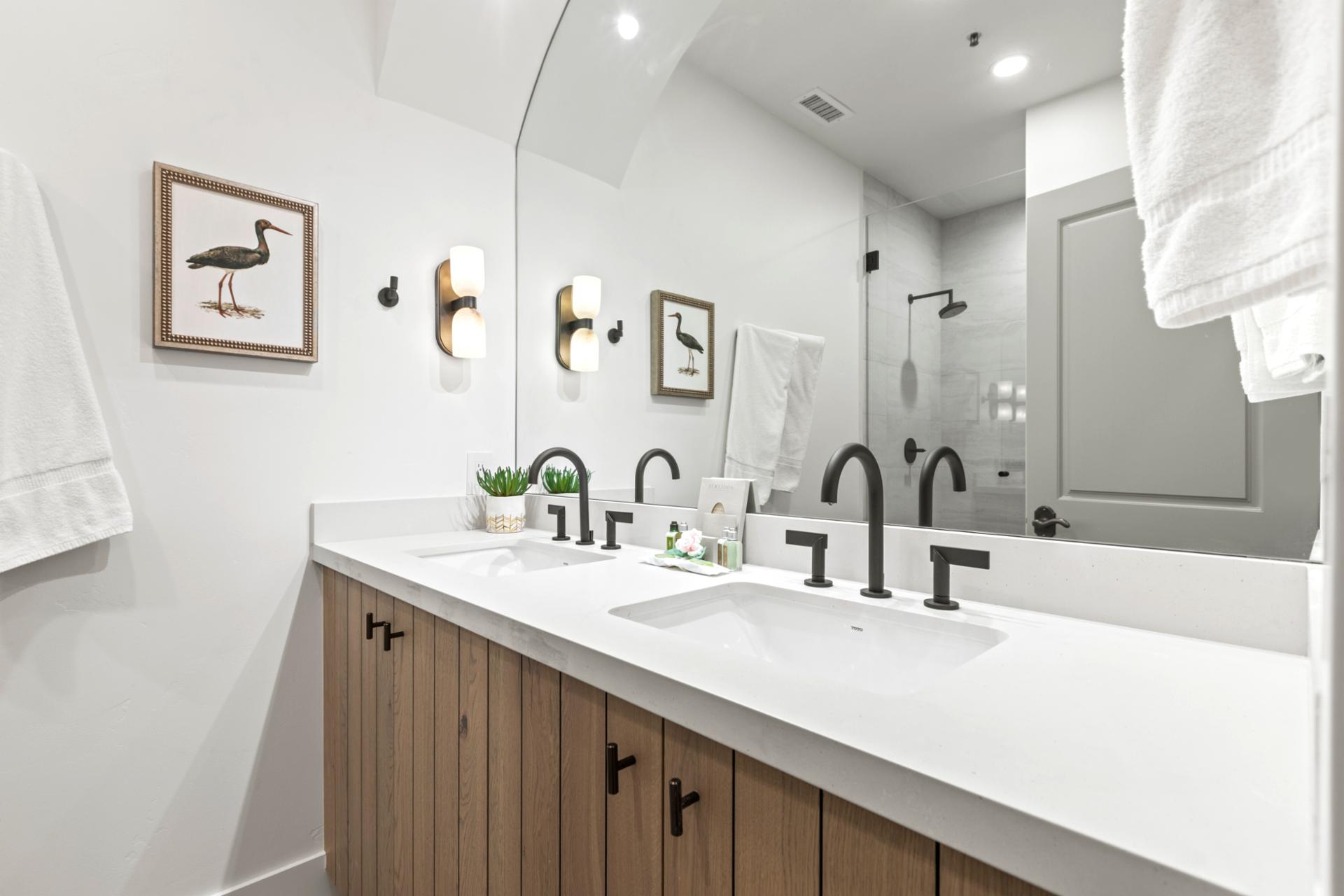 Attached to the bunk room, this full bath includes dual sinks and sleek fixtures.