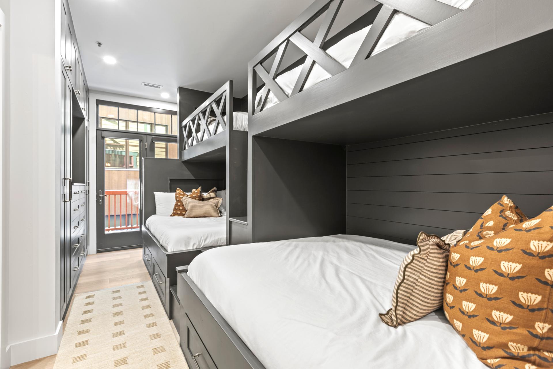 This spacious bunk room sleeps six comfortably with integrated storage and modern design.