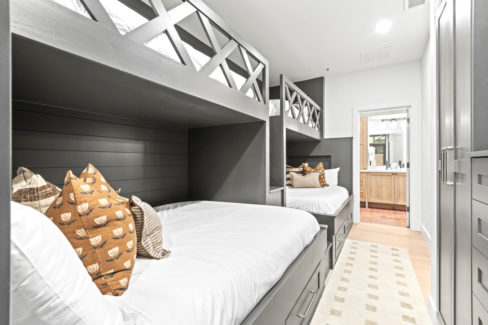 This bunk room features two Queen-over-Twin bunks, perfect for kids or flexible group sleeping.