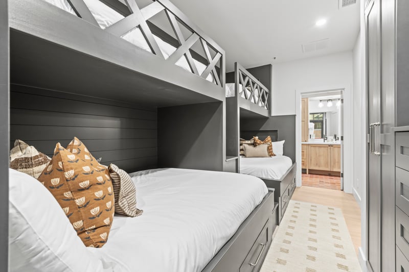 This bunk room features two Twin over  Queen bunks, perfect for kids or flexible group sleeping.
