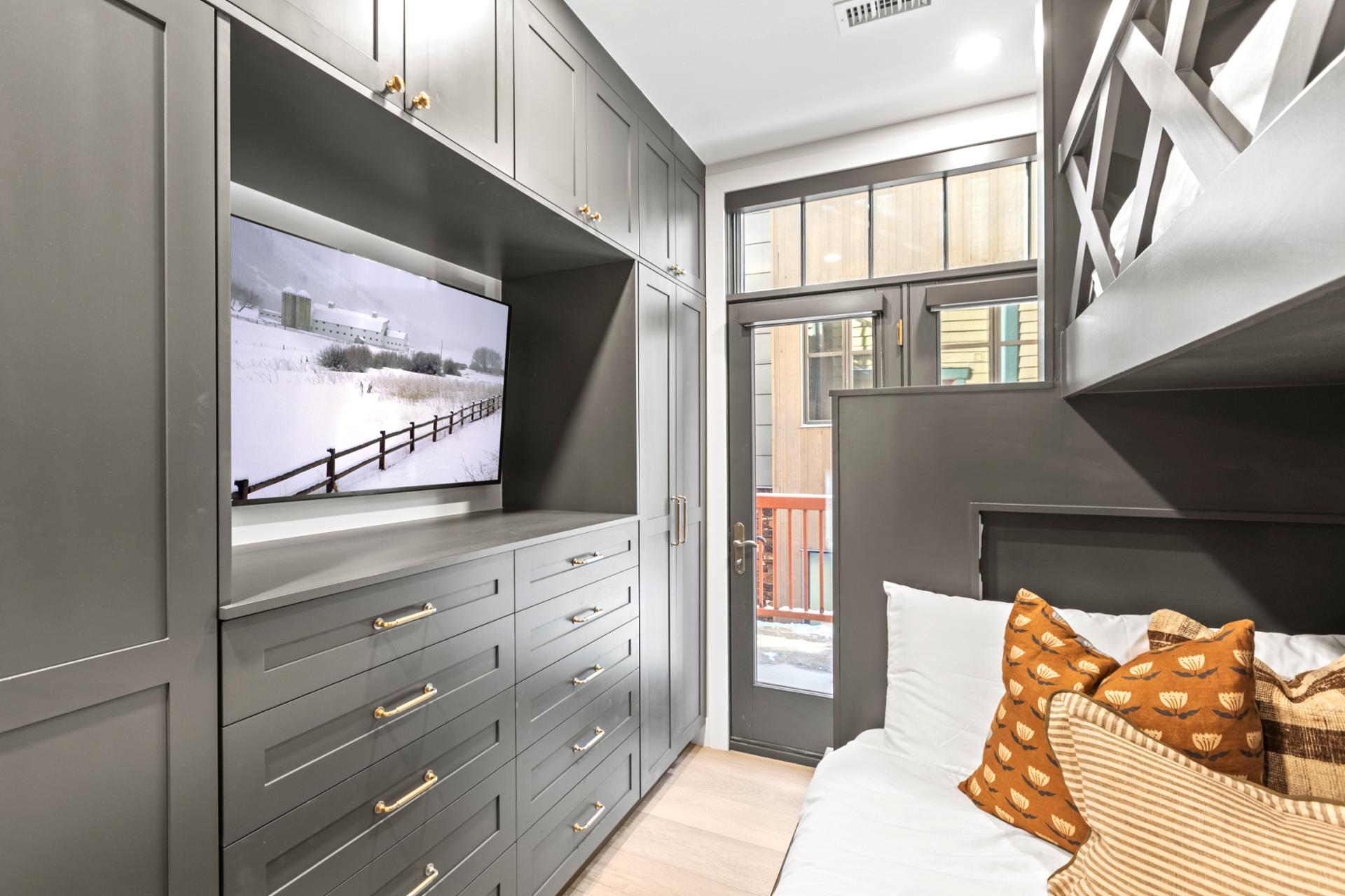 Built-in drawers and individual lighting complete this stylish, multi-bed setup.