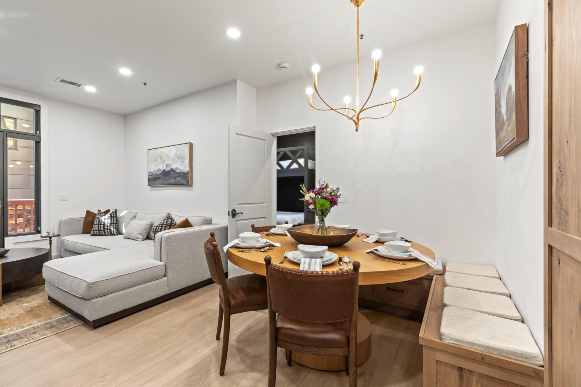 Alternate angle of the dining area shows seamless layout and inviting light fixture.