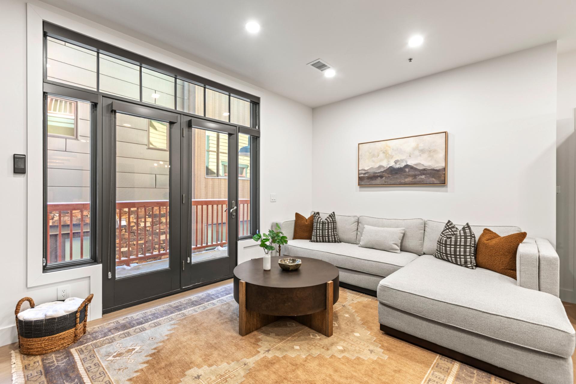 Gather with friends or stream a movie from the L-shaped sectional with access to the balcony.