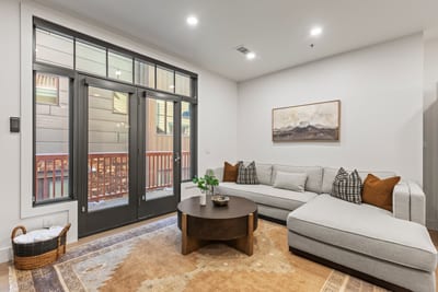 Gather with friends or stream a movie from the L-shaped sectional with access to the balcony.