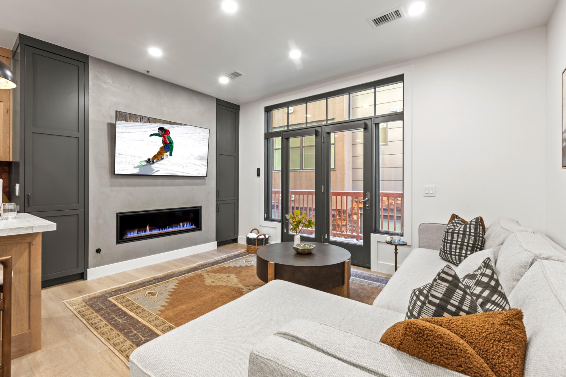 Sliding doors bring in light and mountain views to this spacious lounge area with sectional seating.