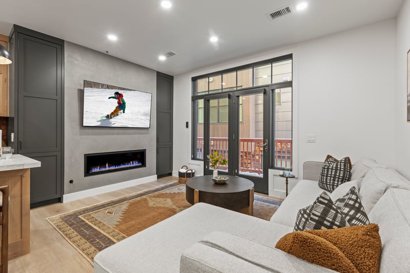 Sliding doors bring in light to this spacious living area with sectional seating.