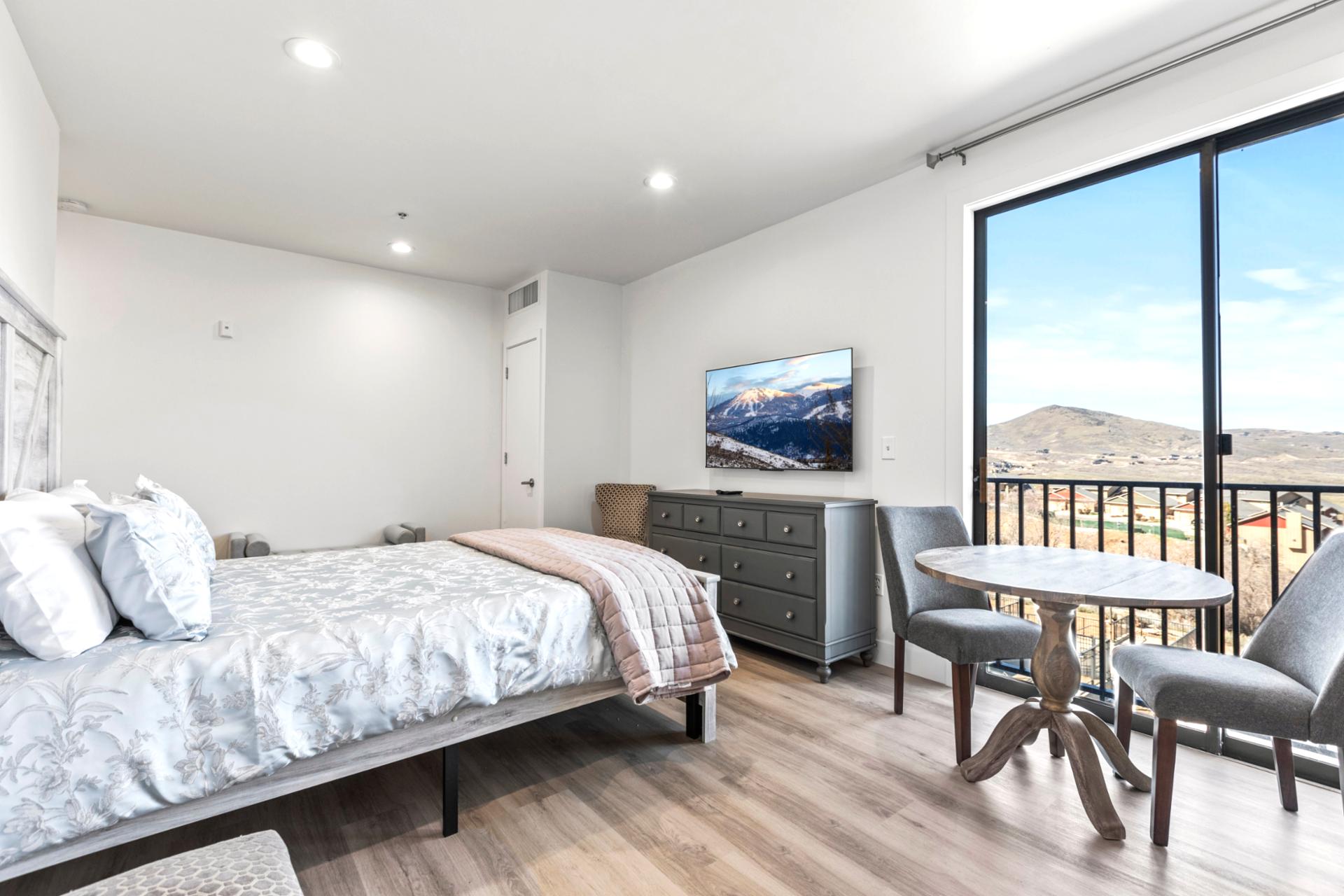 Wake up to sweeping views and private balcony access from this serene Queen bedroom.