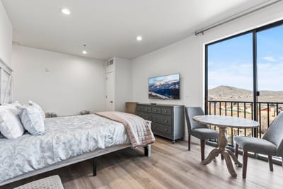 Wake up to sweeping views and private balcony access from this serene Queen bedroom.