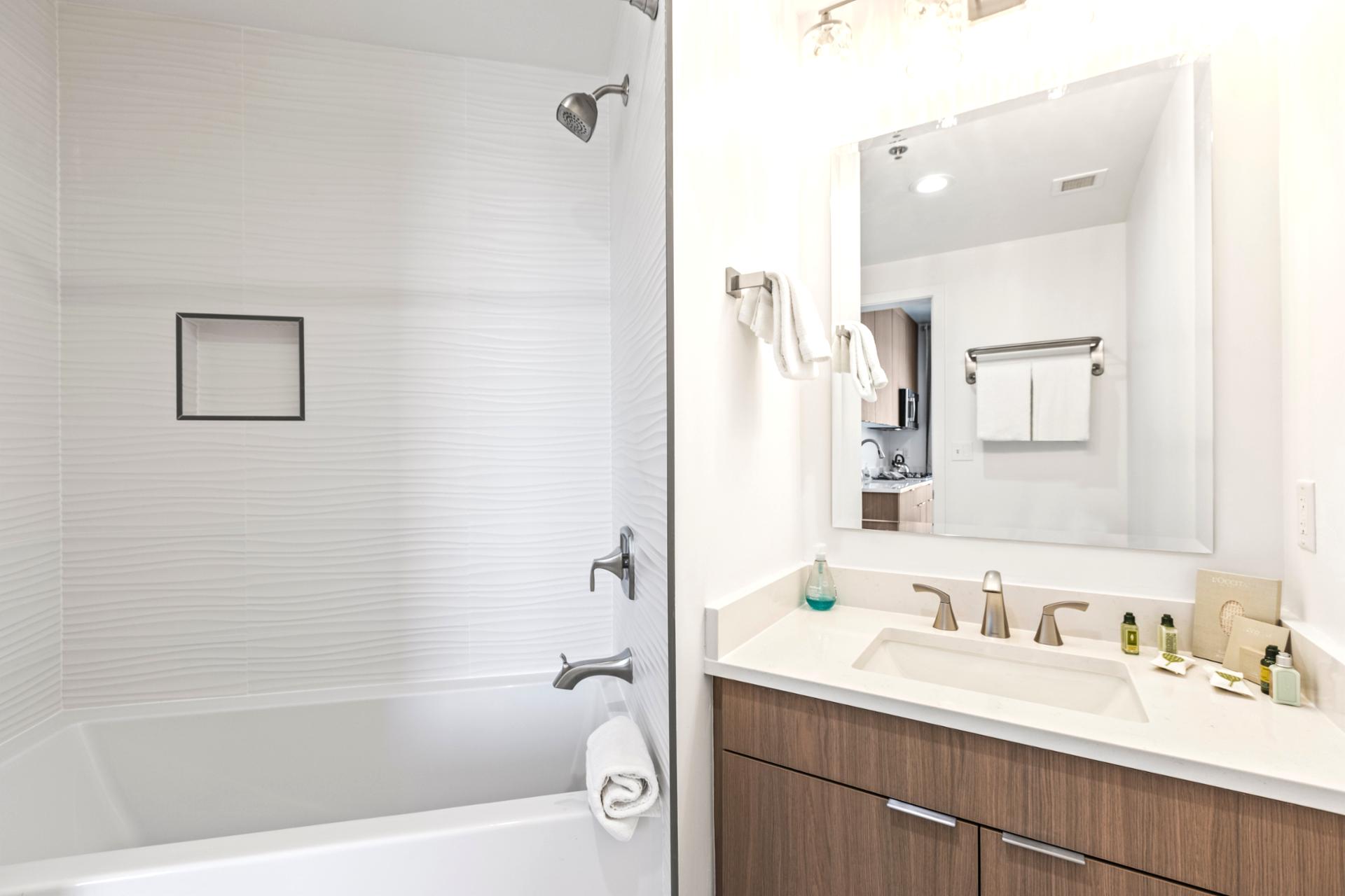 A full guest bathroom with tub and shower combo offers family-friendly flexibility and modern fixtures.