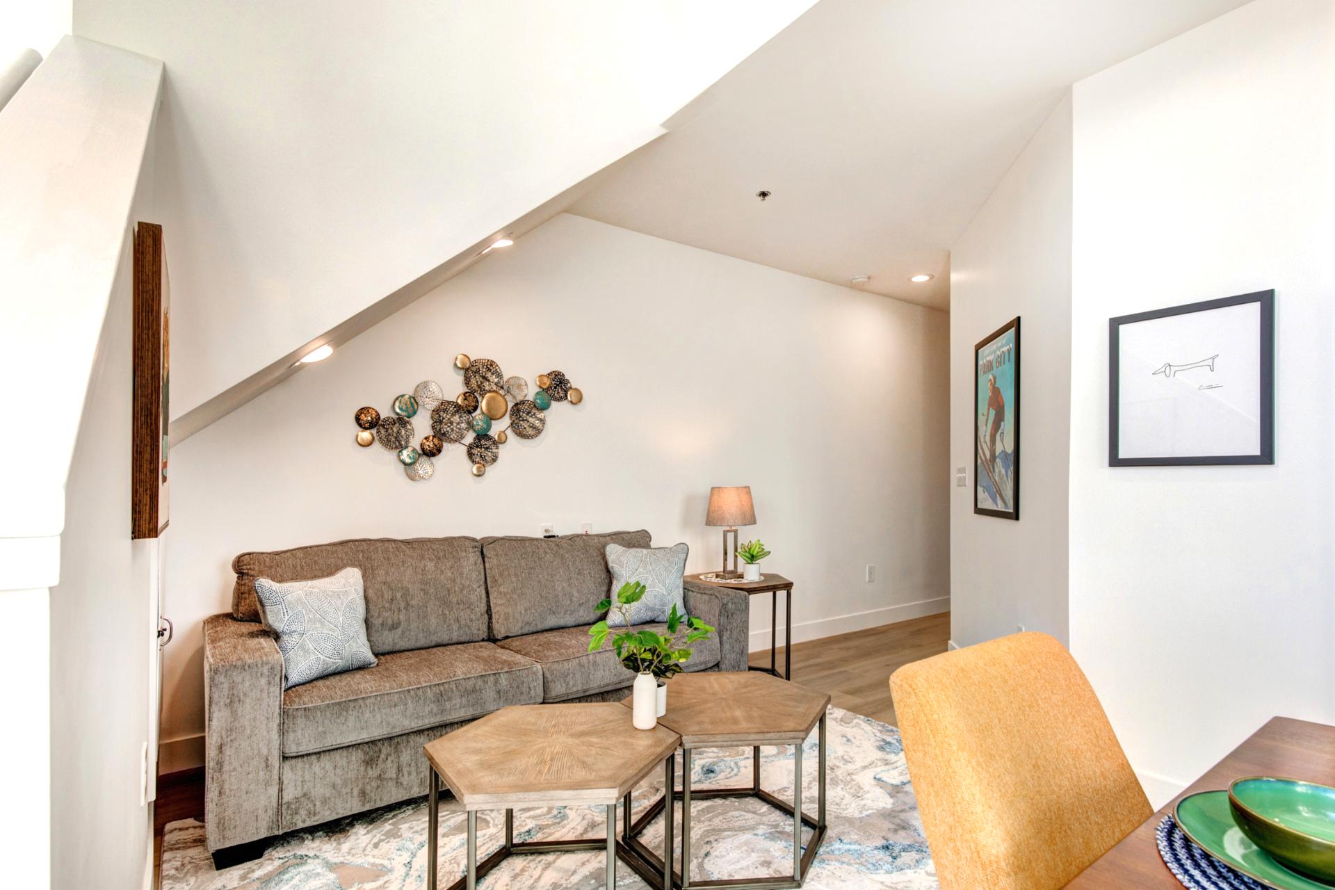 Gather in the open-concept living room with vaulted ceilings, plush seating, and warm natural light.