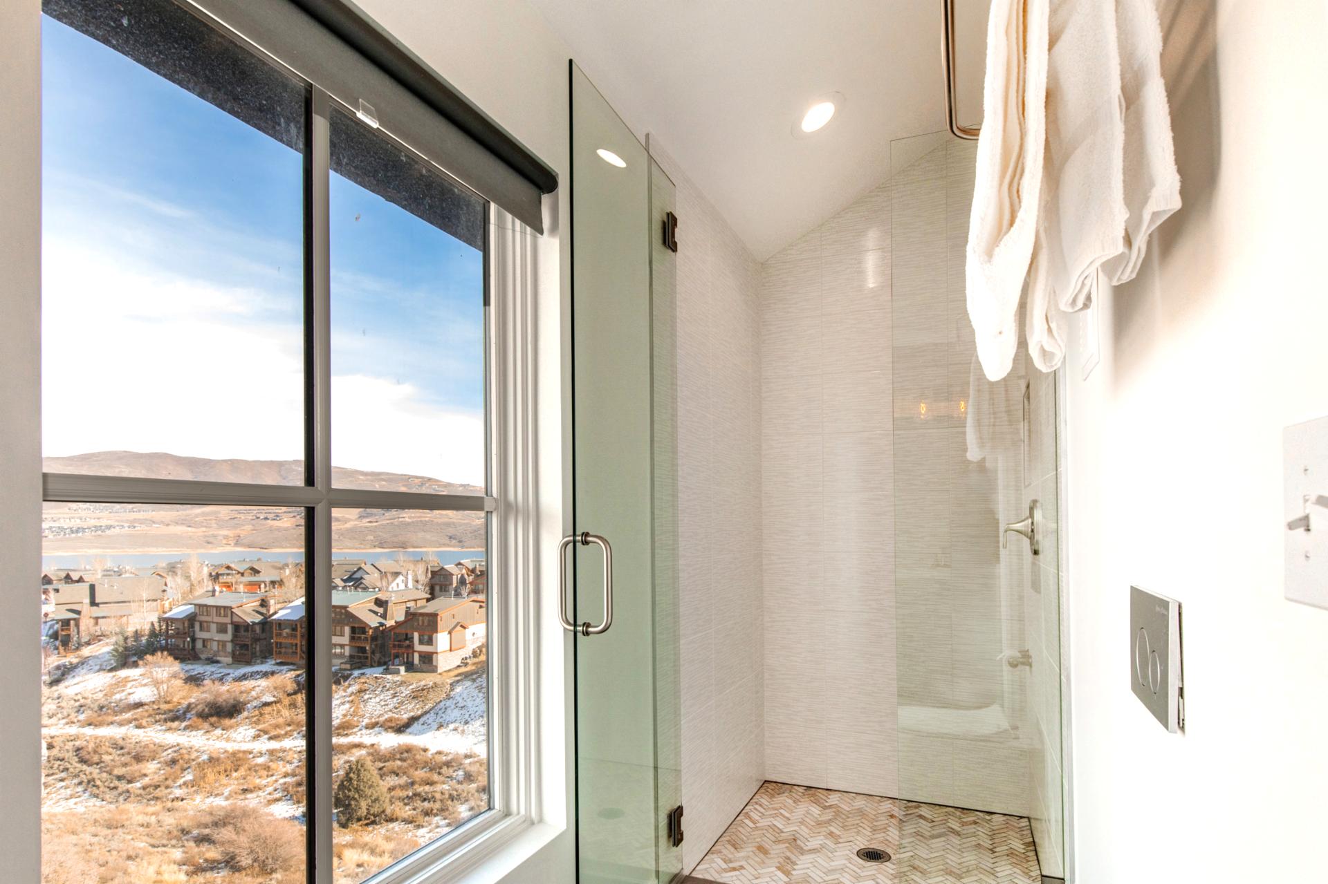 Start the day in your sleek, walk-in shower with spa-style fixtures and a scenic backdrop.