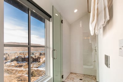 Start the day in your sleek, walk-in shower with spa-style fixtures and a scenic backdrop.
