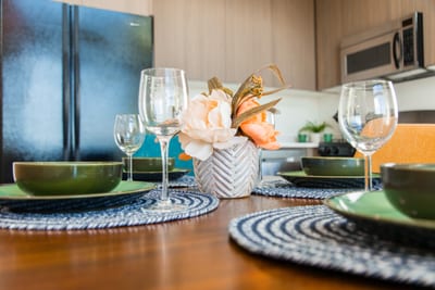 Dine in style with elegant place settings and mountain light pouring in through tall windows.