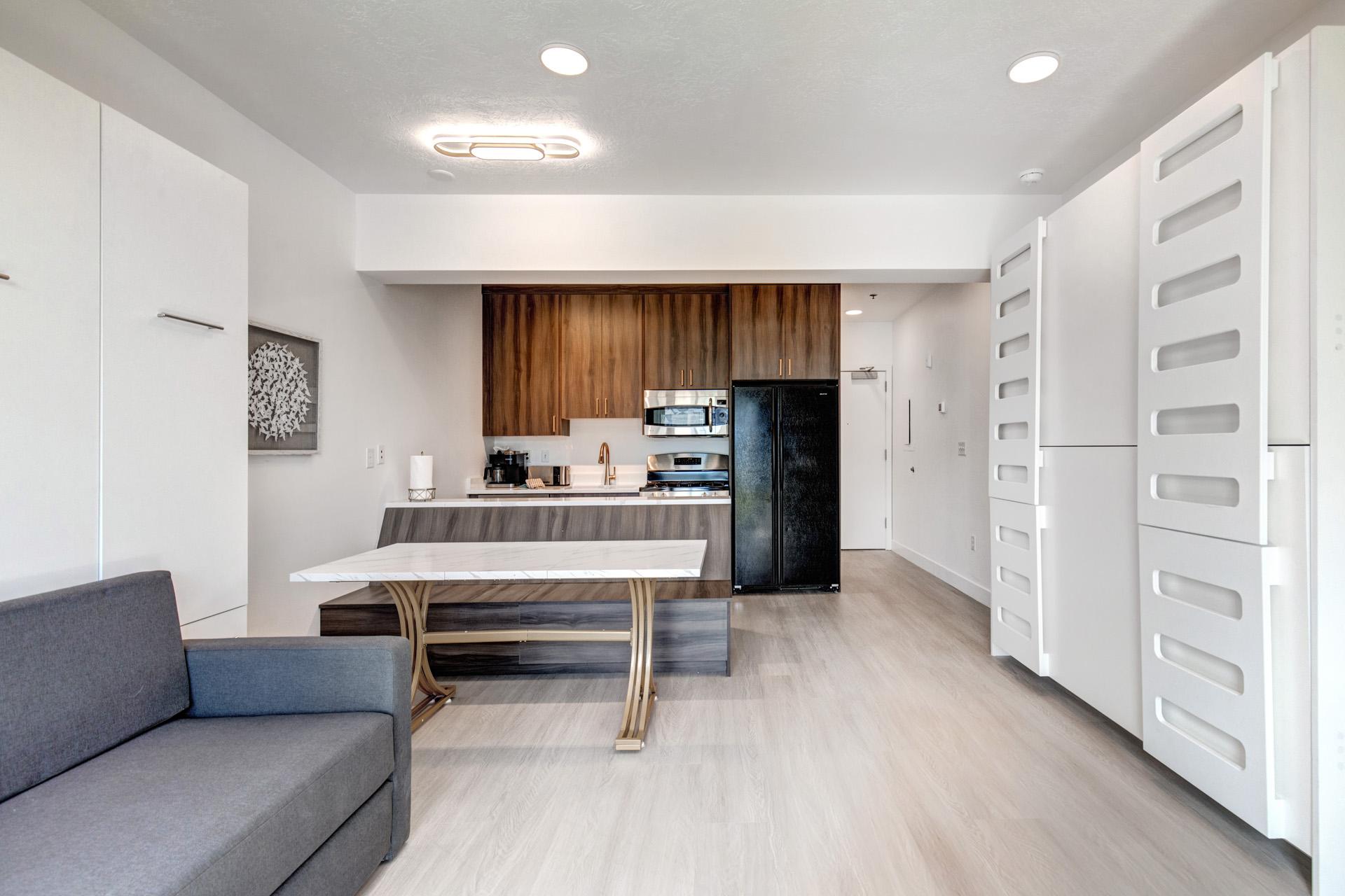 A full kitchen with stainless steel appliances and modern wood cabinetry makes in-unit cooking a breeze.