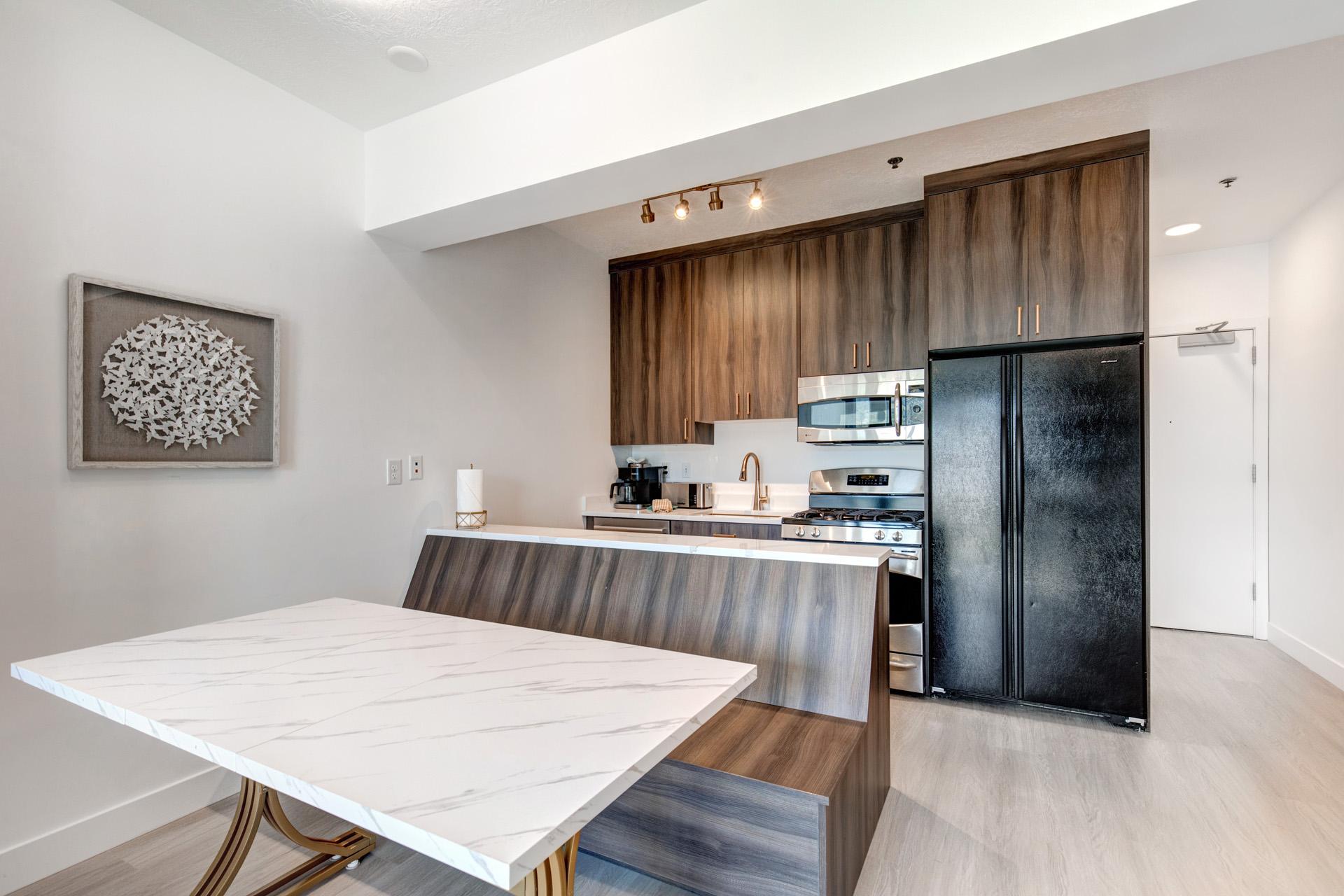 Modern lighting and soft neutral tones make this open dining area feel both fresh and inviting.