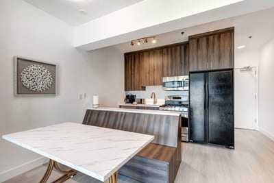 Modern lighting and soft neutral tones make this open dining area feel both fresh and inviting.