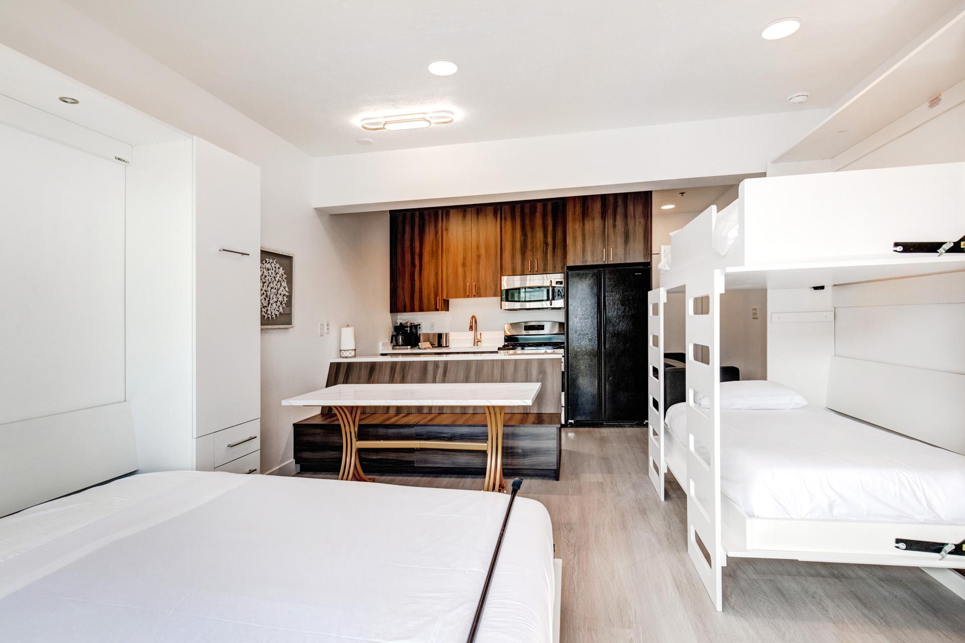 Twin bunk beds create a kid-friendly or friends-friendly sleep zone in the corner of the main living area.