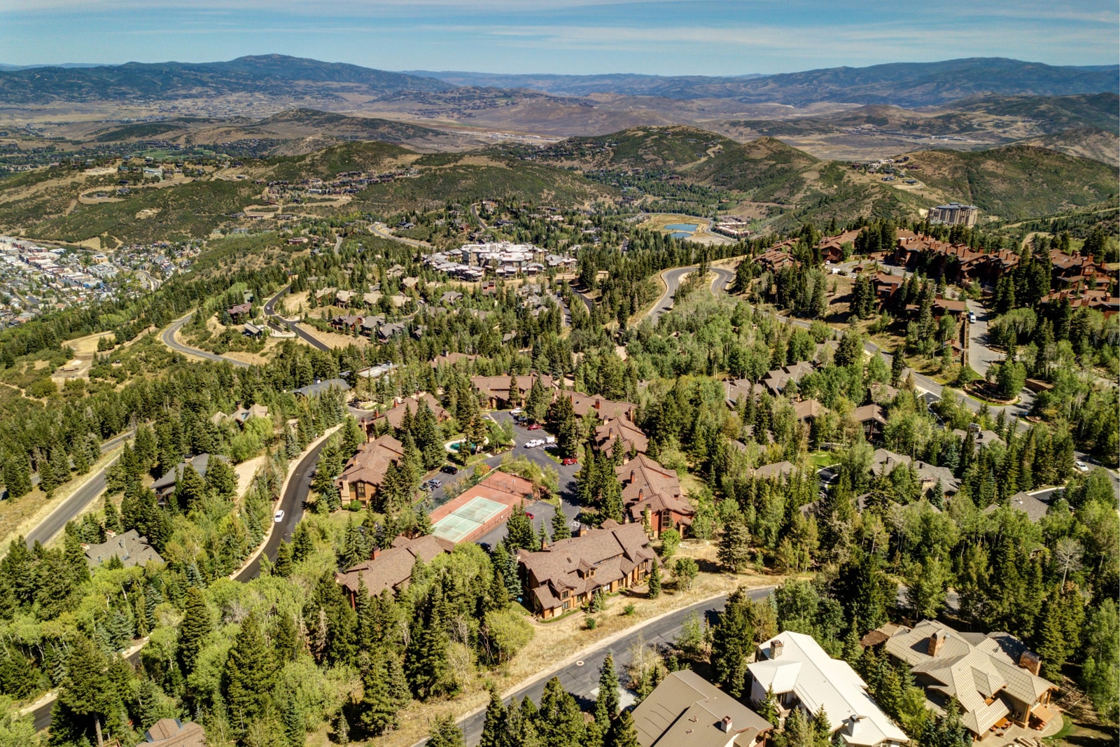 Aerial view of the Ridgepoint complex nestled among pines and trails.