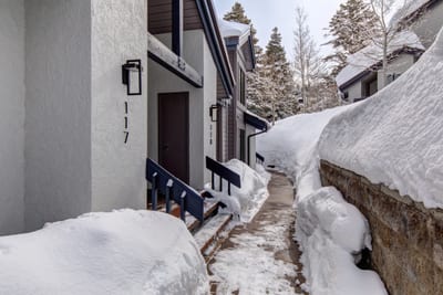 A clear, shoveled path leads to your cozy mountain escape.