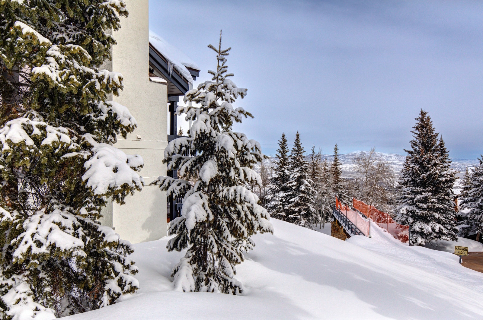 Snow-covered grounds create a true winter wonderland setting.