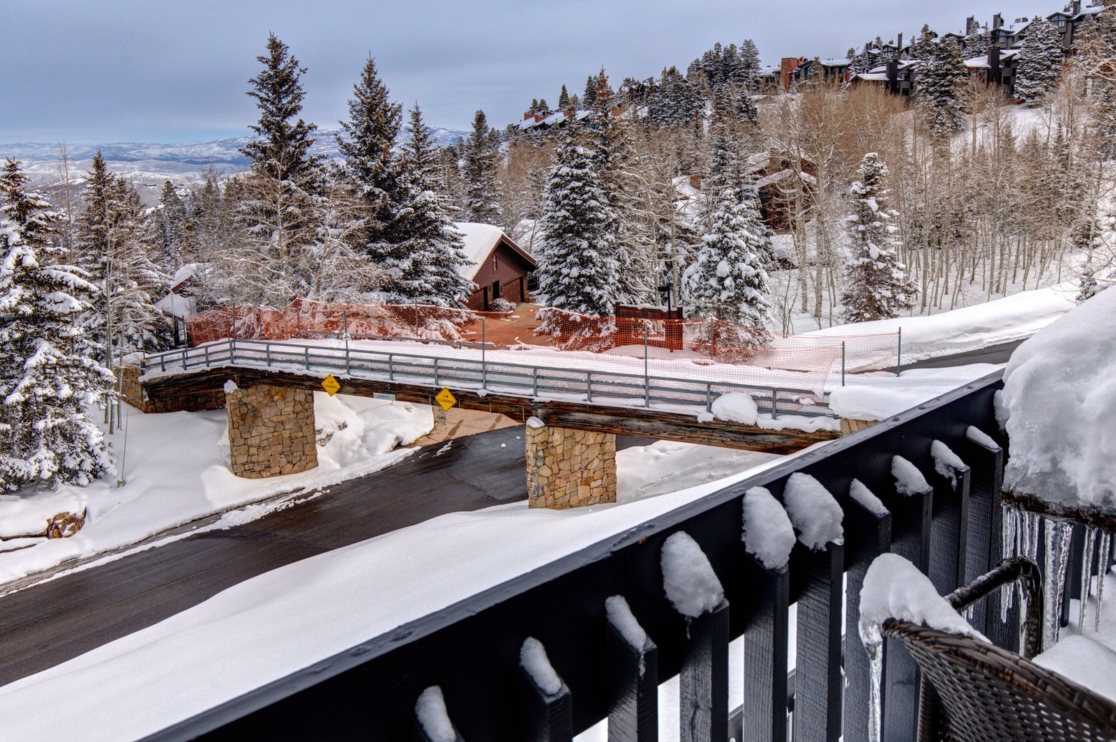 Take in peaceful views of snow-dusted rooftops and alpine trees from your private deck.