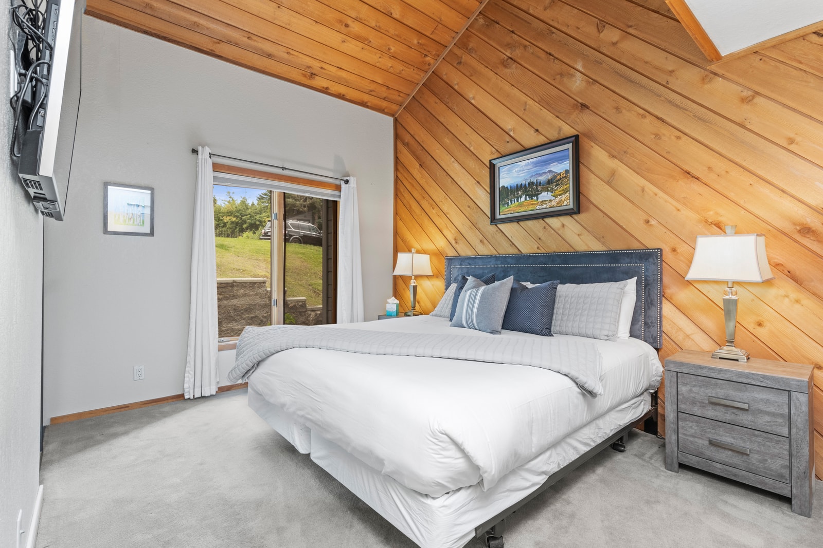 Primary bedroom with a King bed, vaulted ceilings, and ensuite bath.