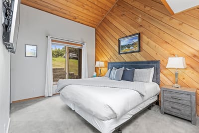 Primary bedroom with a King bed, vaulted ceilings, and ensuite bath.