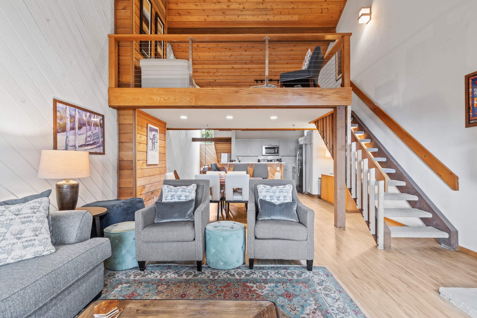 An alternate angle shows seamless flow between the living, dining, and kitchen spaces.