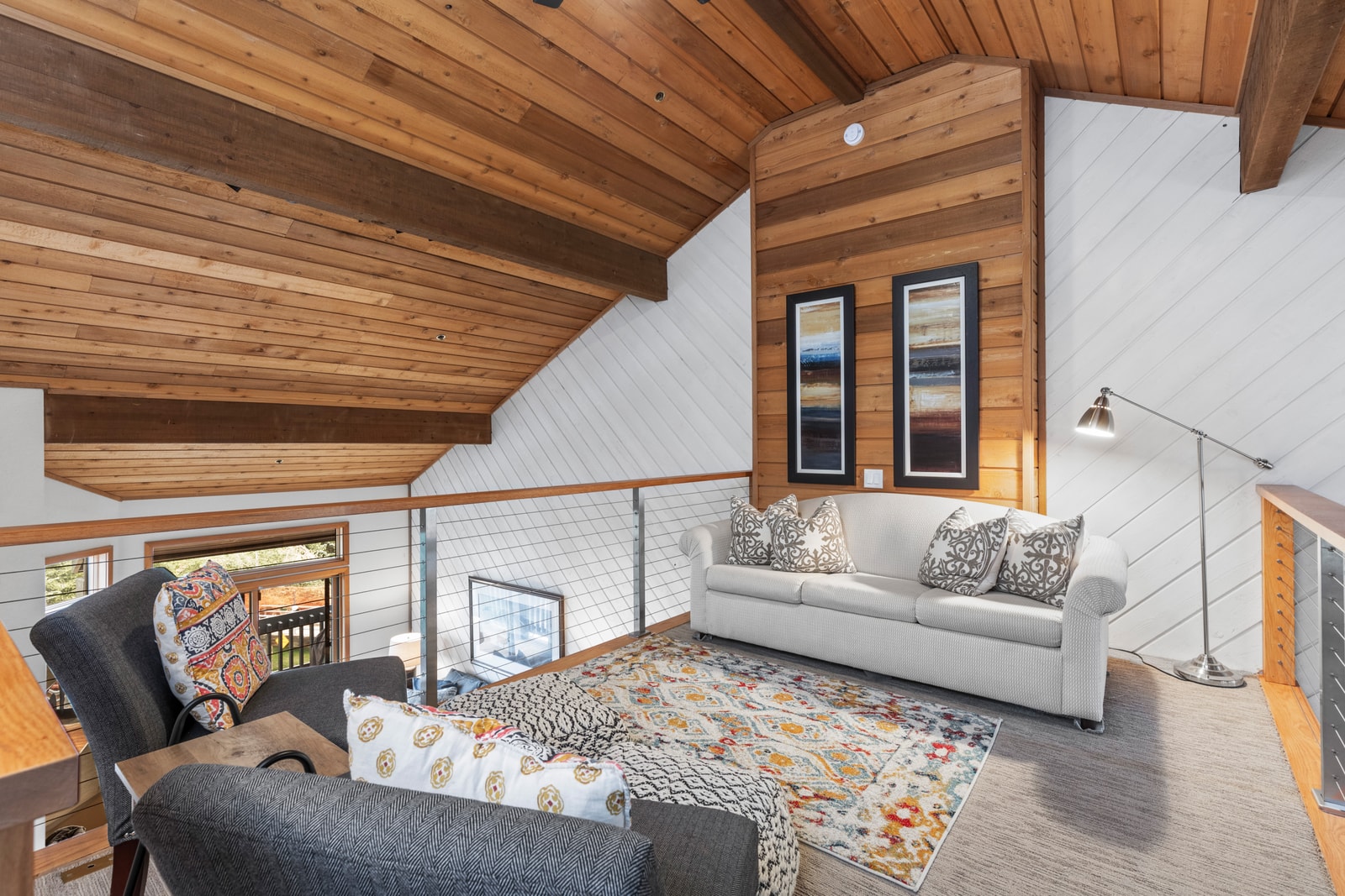 Lofted den with additional seating offers space to spread out and relax.