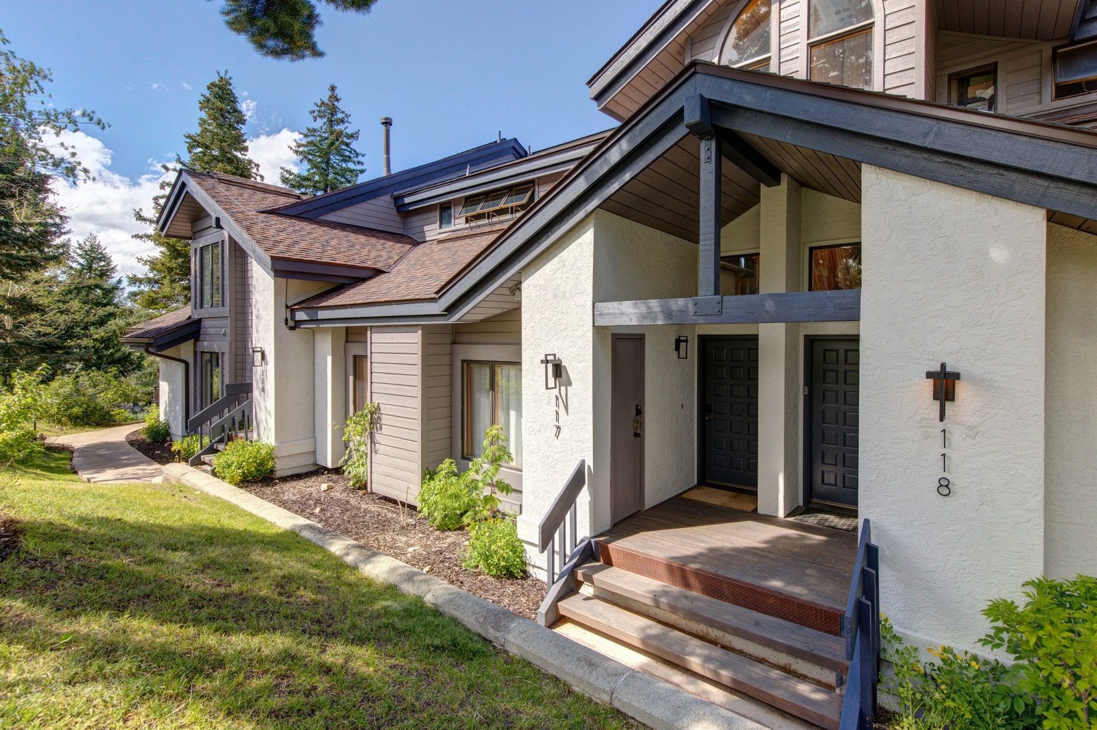 Lush landscaping and charming architectural details welcome you home.
