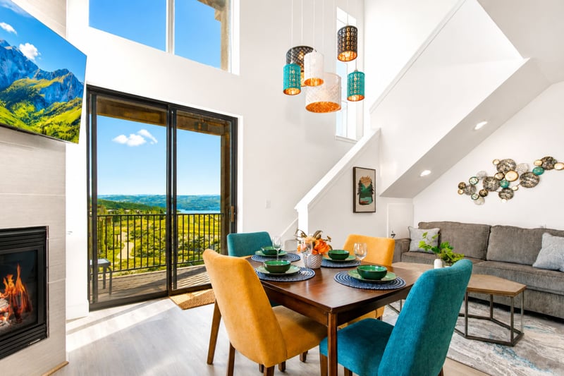 Sit down to dinner at Mountain Dream's dining table, framed by a gas fireplace and floor-to-ceiling views of the valley below.