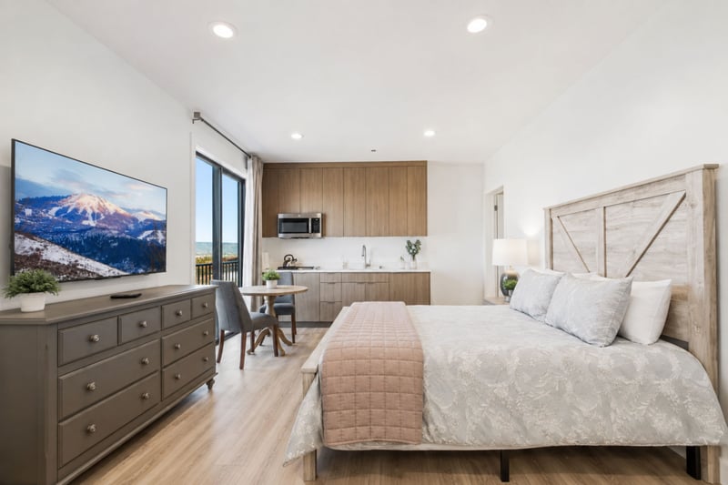 This queen suite includes its own kitchenette and dining table, giving guests a private retreat with all the comforts of home.