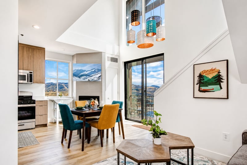 Vaulted ceilings and a stacked-stone fireplace anchor the great room, with mountain views pouring in through floor-to-ceiling glass.