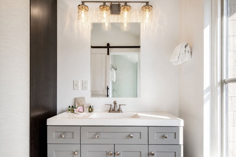 A double vanity and rustic barn-door accents give the primary bath a warm, mountain-modern feel.