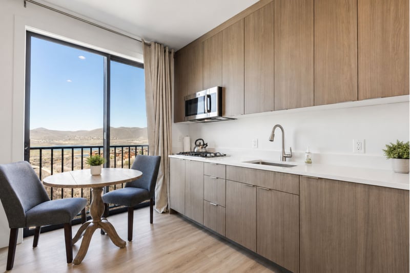 Brew your morning coffee in the guest suite's private kitchenette, then enjoy it at the two-top table with sweeping valley views.