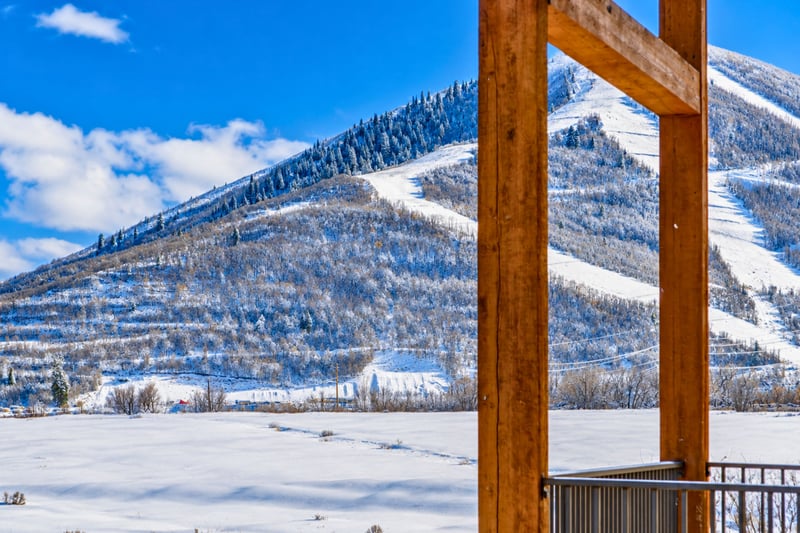 Framed by the resort's timber beams, this view looks straight up the ski runs above The Mason.