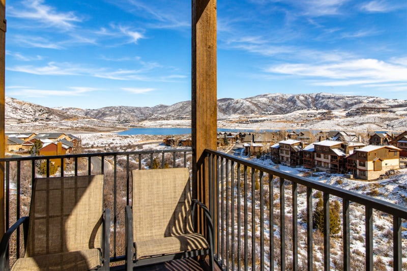 By day, your balcony looks out over Jordanelle Reservoir, the village rooftops, and the mountains beyond.