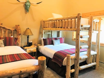 The guest room sleeps up to six with two Queen beds and a Twin XL over Queen bunk, ideal for families.