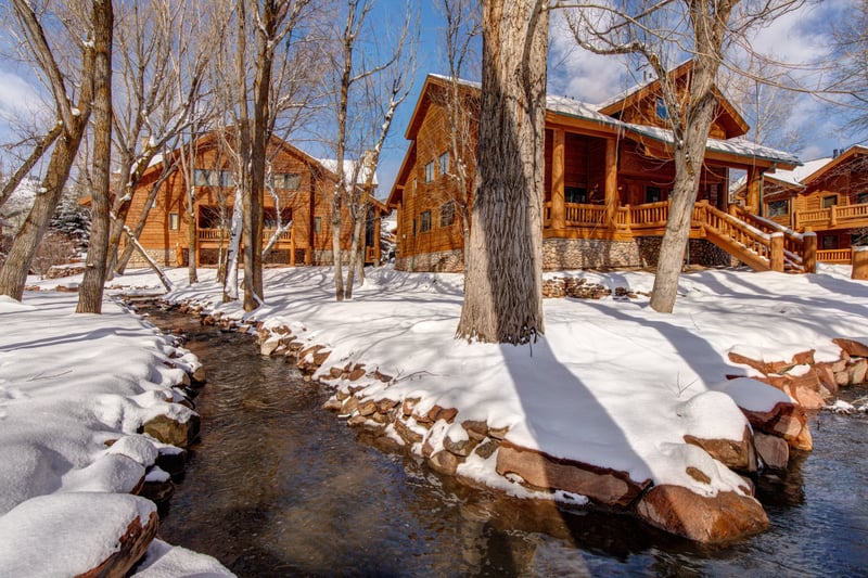 Snow-covered lodge-style building in winter, with outdoor areas perfect for year-round enjoyment.